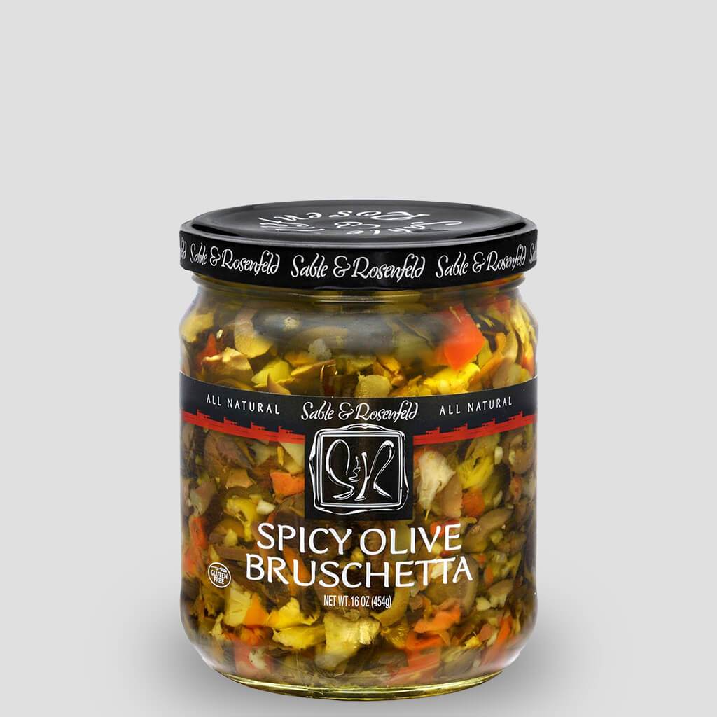 A jar of Sable & Rosenfeld Spicy Olive Bruschetta filled with a colorful blend of chopped olives, peppers, and herbs, perfect for adding a zesty kick to any dish.